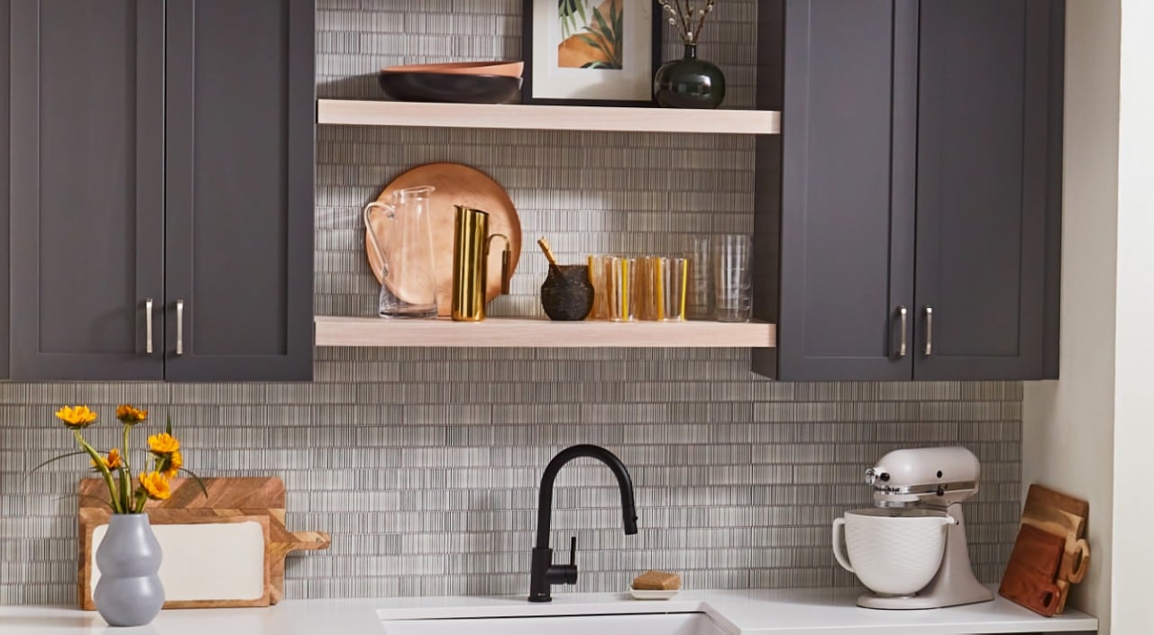 Gray cabinets, open shelving and countertop with stand mixer 