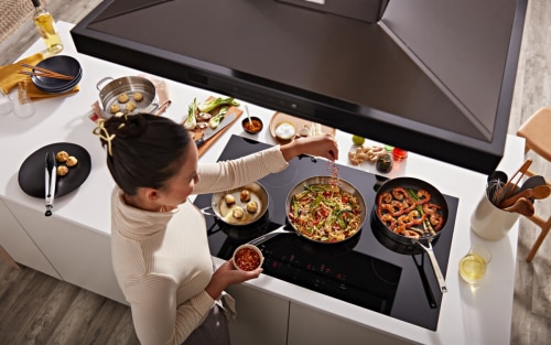 Person cooking on an electric cooktop