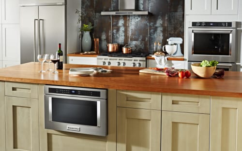 A KitchenAid® Drawer Microwave, surrounded by cabinetry