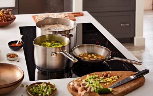 Ingredients and an induction cooktop on a kitchen island
