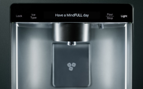 A close-up of the water dispenser of a MindFULLness Fridge
