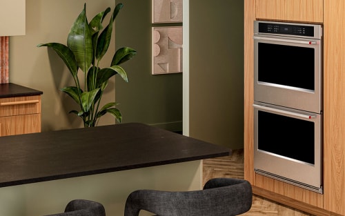 A modern kitchen with an island and double wall oven