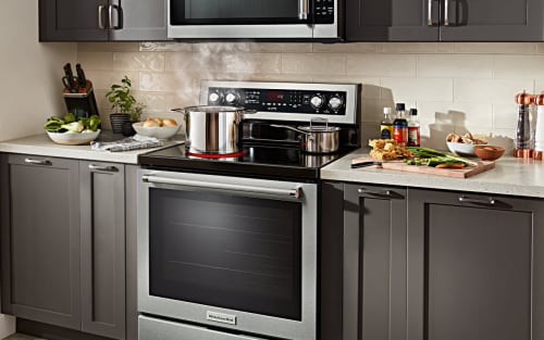 A kitchen with various pots on a range