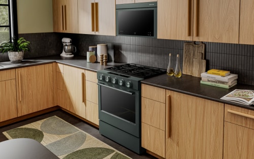 a KitchenAid® gas range set in modern cabinetry