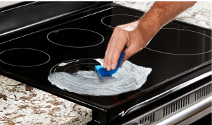 Cleaning cooktop.