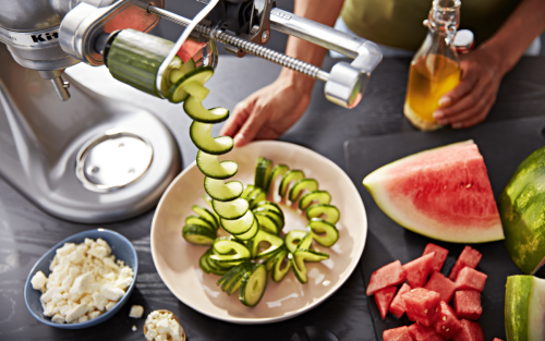 A red KitchenAid® Stand Mixer with Spiralizer Attachment.