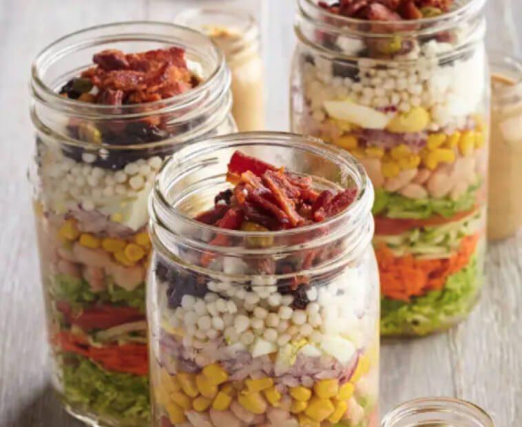 Mason jars with layered salad. Mason jars with layered salad.
