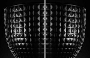 A closeup of both the black ceramic studded bowl and the black stainless steel bowl.