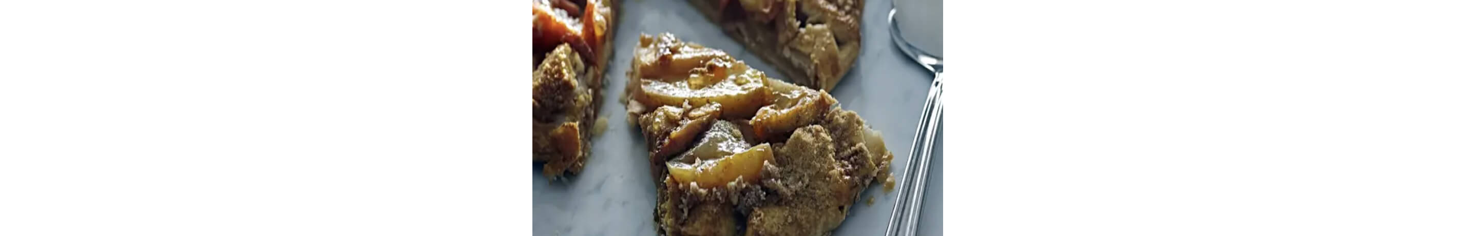 Slice of apple crostata on a stone countertop.