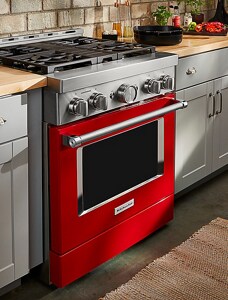 A KitchenAid® commercial-style range with stainless steel cookware on the stovetop