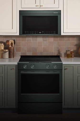 A KitchenAid® Over-the-Range microwave installed above a sleek, slide-in range