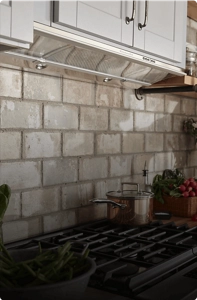 A KitchenAid® Hood Liner installed above a gas cooktop