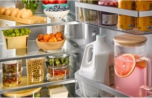 A KitchenAid® refrigerator with fully stocked glass shelves and bins