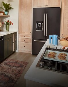 A side-by-side KitchenAid® refrigerator installed between light wood cabinets