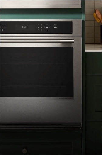 A single wall oven in a green contemporary kitchen.