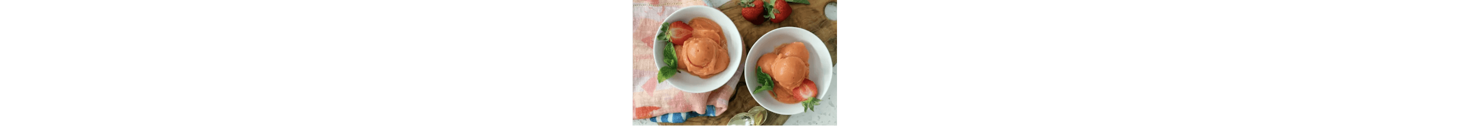 Two bowls of Healthy No-Churn Fruit Sorbet paried with mint and strawberries.