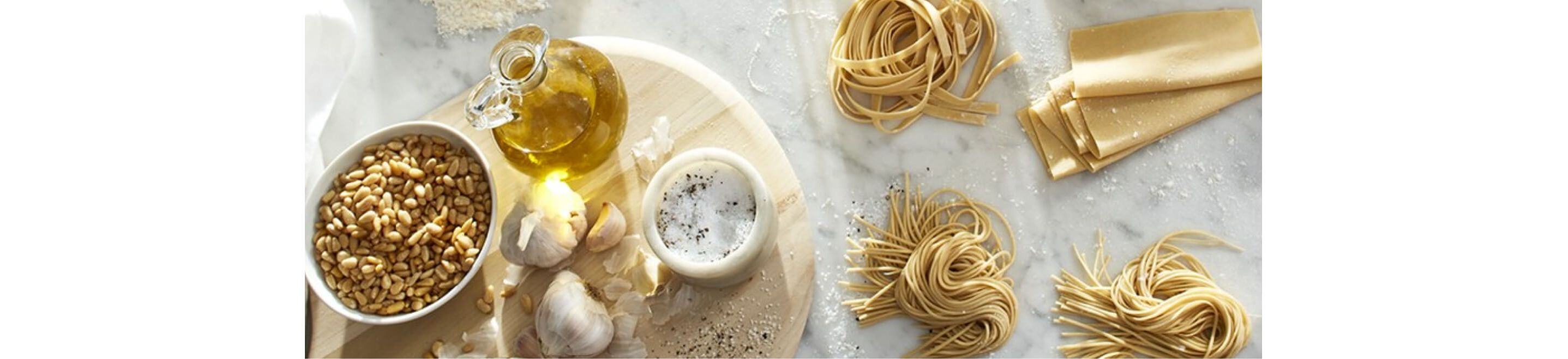 Homemade pasta nests and ingredients on a kitchen counter