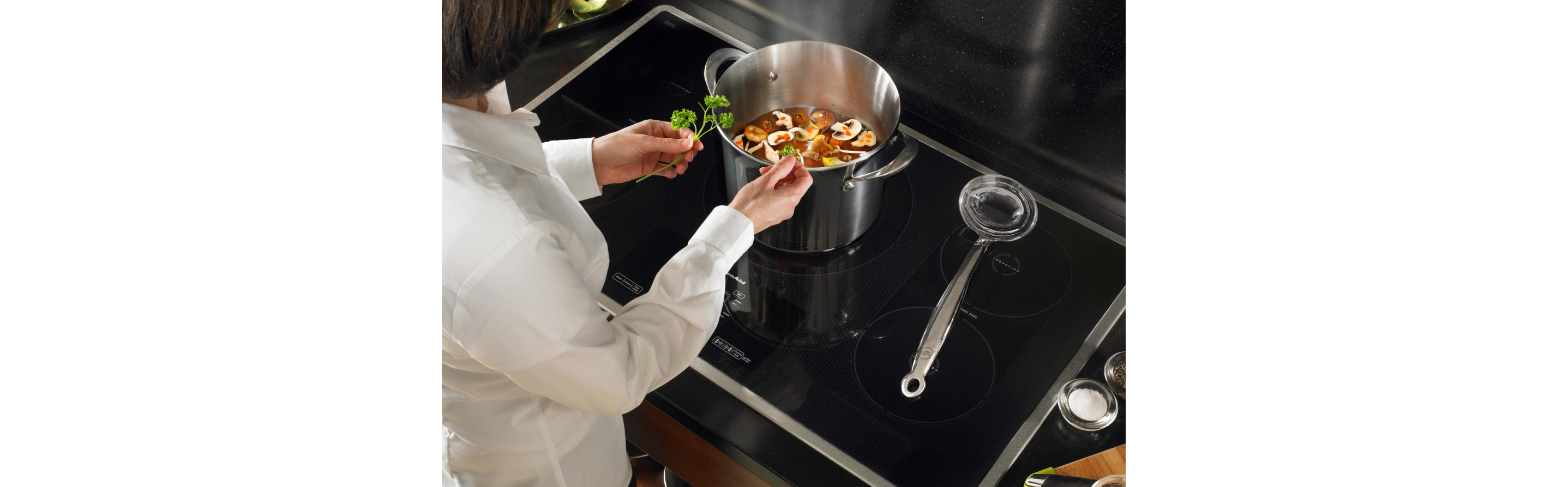 Woman cooking on an induction cooktop.
