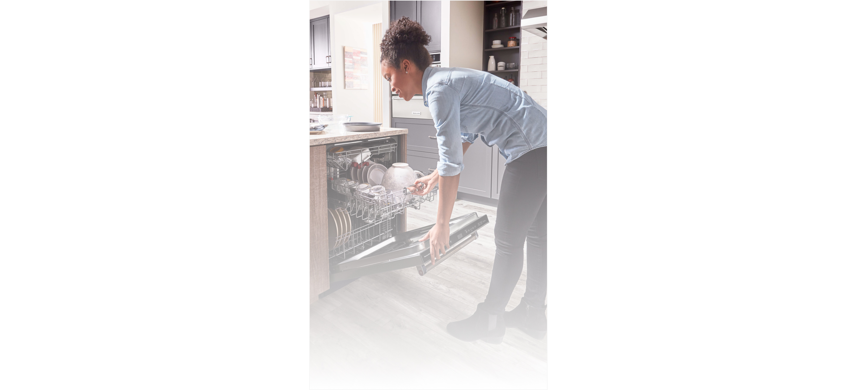 Woman closing a dishwasher 
