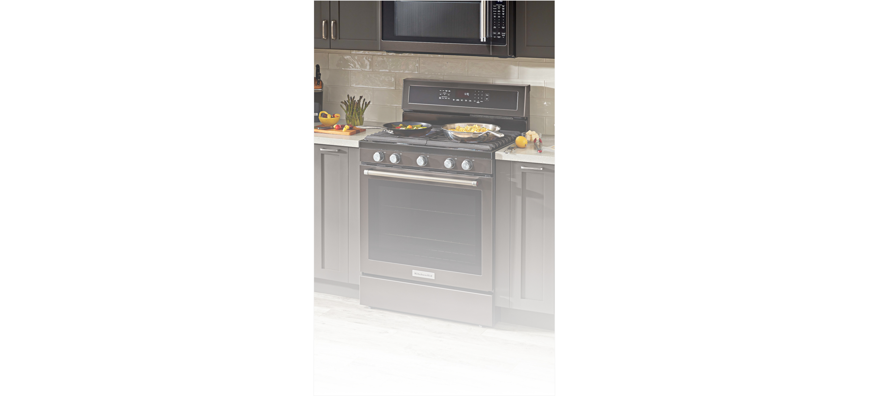 A range in a kitchen with dark cabinets 