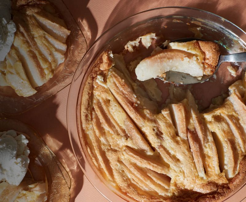 A trio of freshley baked desserts in bowls, garnished with ice cream and a scoop missing from the bowl. 