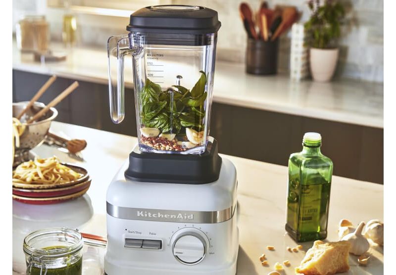 White High Performance blender with all the ingredients for fresh pesto ready to be blended.