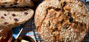 A loaf and slices of Honey Oat Walnut bread.