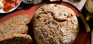A loaf and slices of Whole Wheat Seed bread.