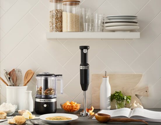 A kitchen counter featuring a Matte Black Cordless Chopper and Hand Blender.