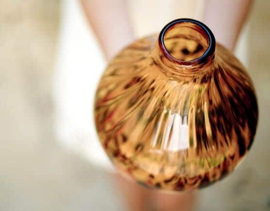 A person holding a glass vase.