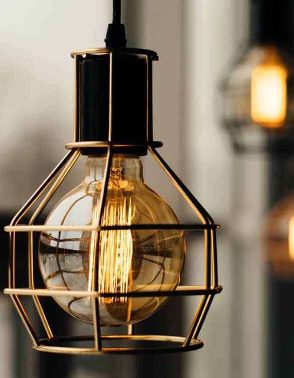 A dark industrial lamp with a honey glow.