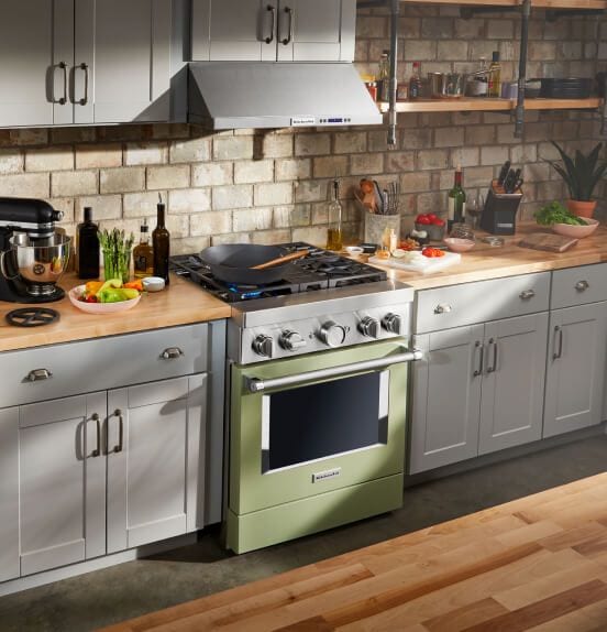 A sun-filled kitchen featuring an Avocado Cream Commercial-Style Range.