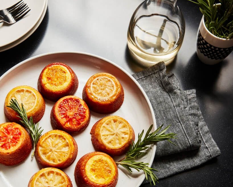 A white plate with delicate citrus pastries.
