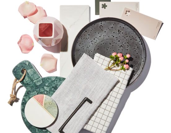 A white table with unique plateware, napkins and coasters.