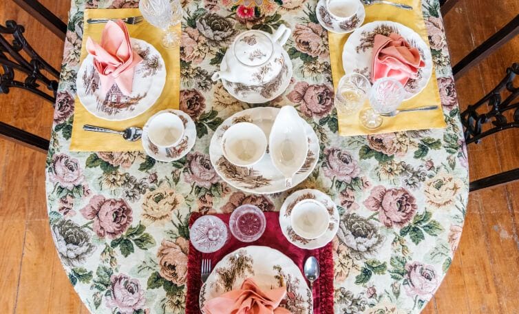 A set floral dining table with a full set of unique, delicate china.