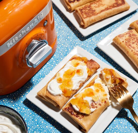 Freshly made, plated pastries next to a K400 Variable Speed Blender in Honey.