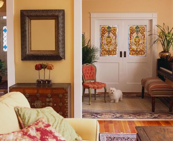 A front entryway and living room with a variety of unique furniture.