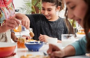 Young people making a delicious dish with golden honey.