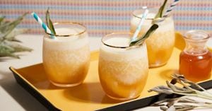 A tray with three glasses filled with freshly made orange julius smoothies.