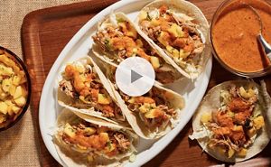 A large oval plate filled with Peri Peri chicken tacos.