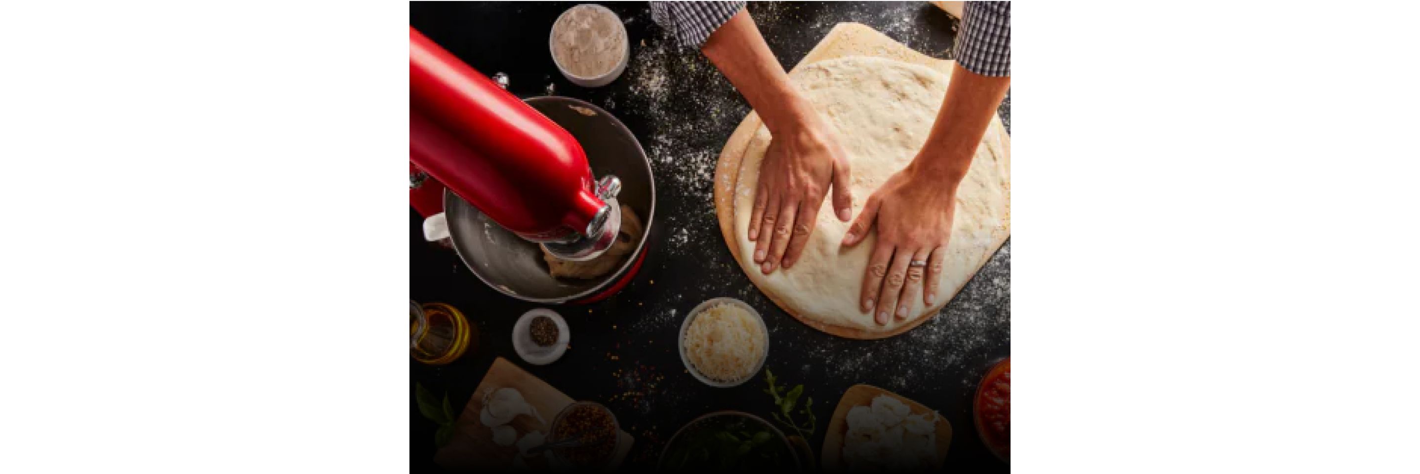 A person using a KitchenAid® stand mixer to create dough.