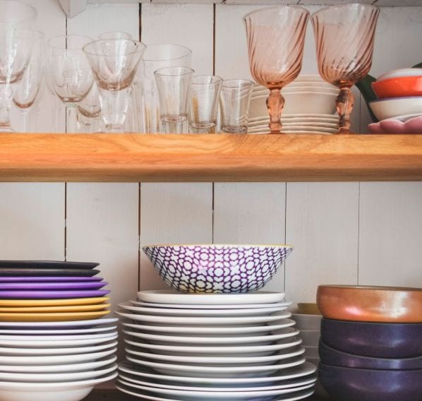A variety of copper and purple dishes.