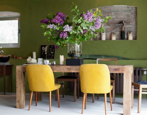 A dining room table featuring ornate flowers.