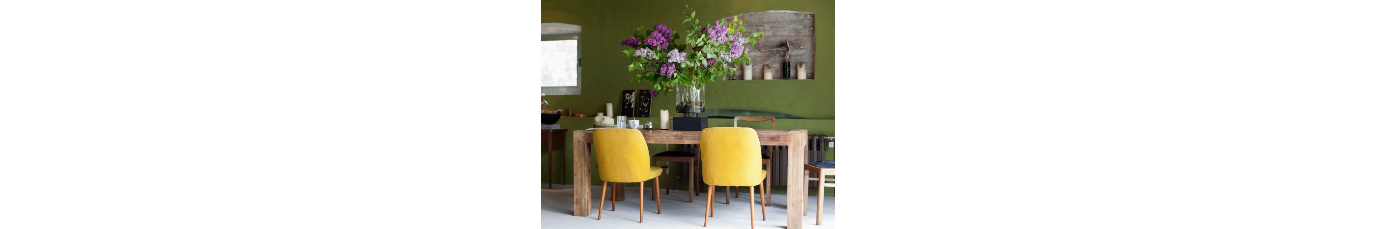 A dining room table featuring ornate flowers.