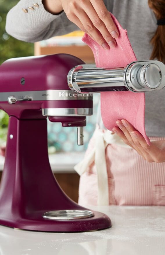 An Artisan® Series Stand Mixer in Beetroot making pasta.