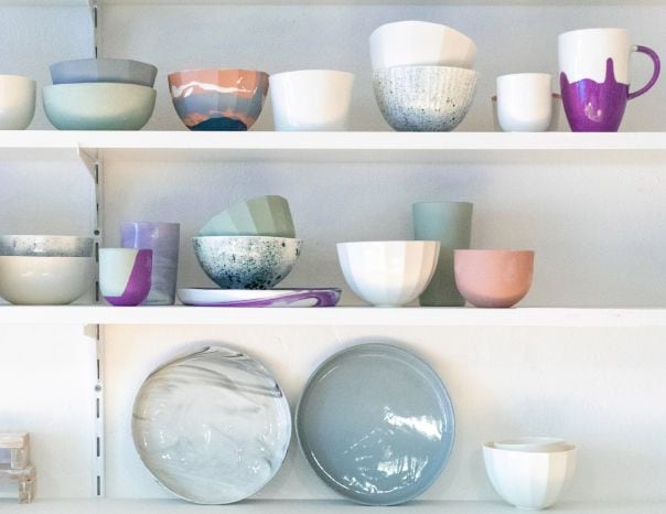 Shelves featuring bowls of different sizes and colors.