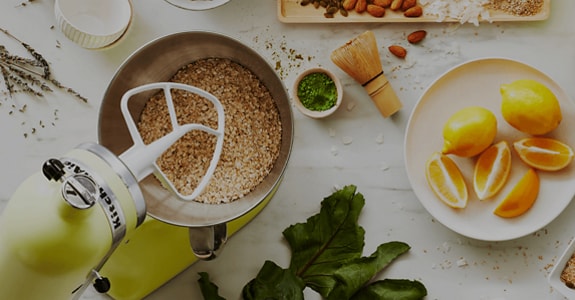 A Kyoto Glow stand mixer prepping granola and yogurt for homemade parfaits.