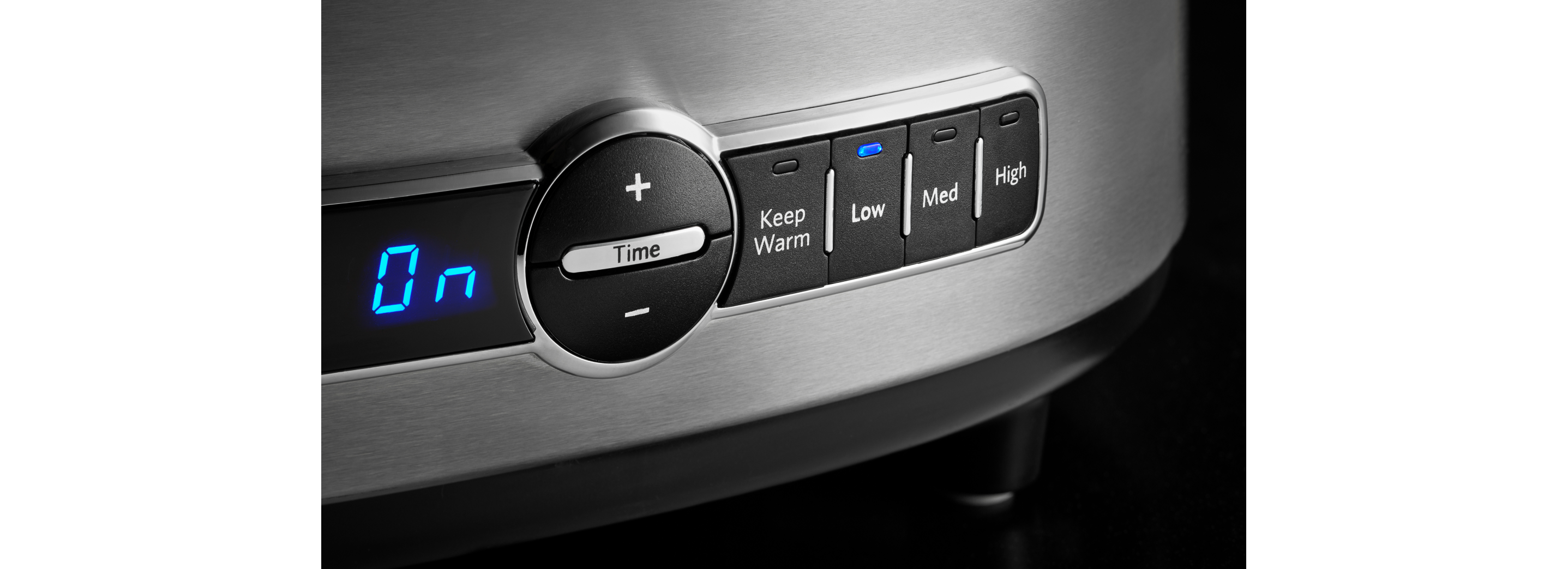 The lit up controls on a KitchenAid slow cooker.