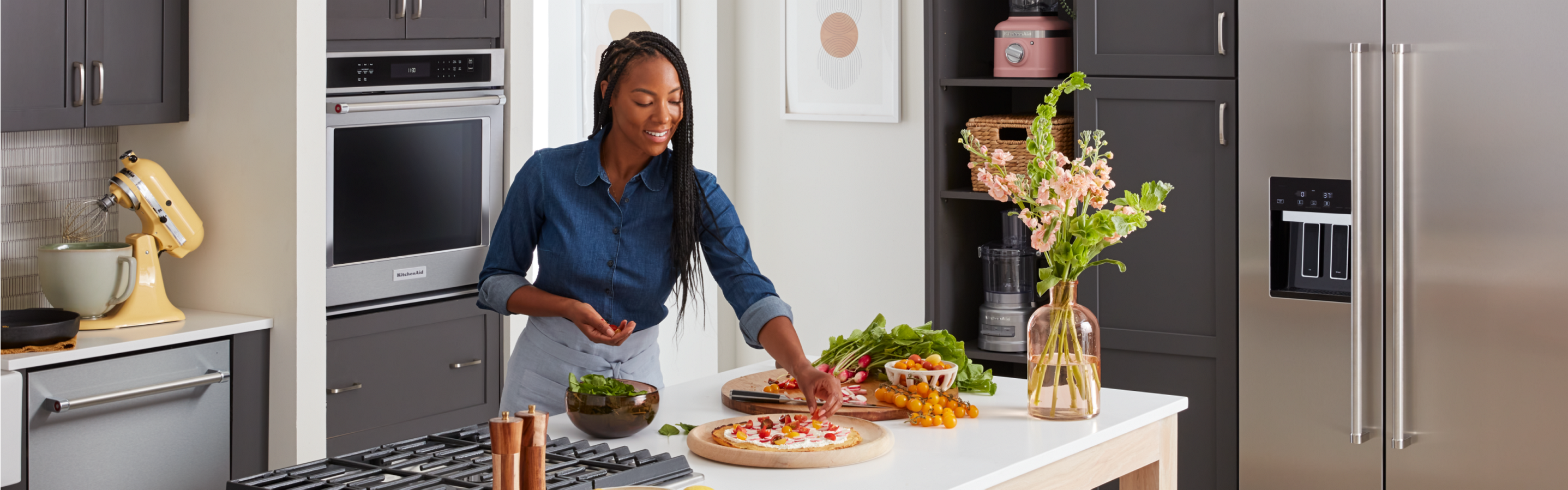 A person placing the finishing touches on cooked dishes