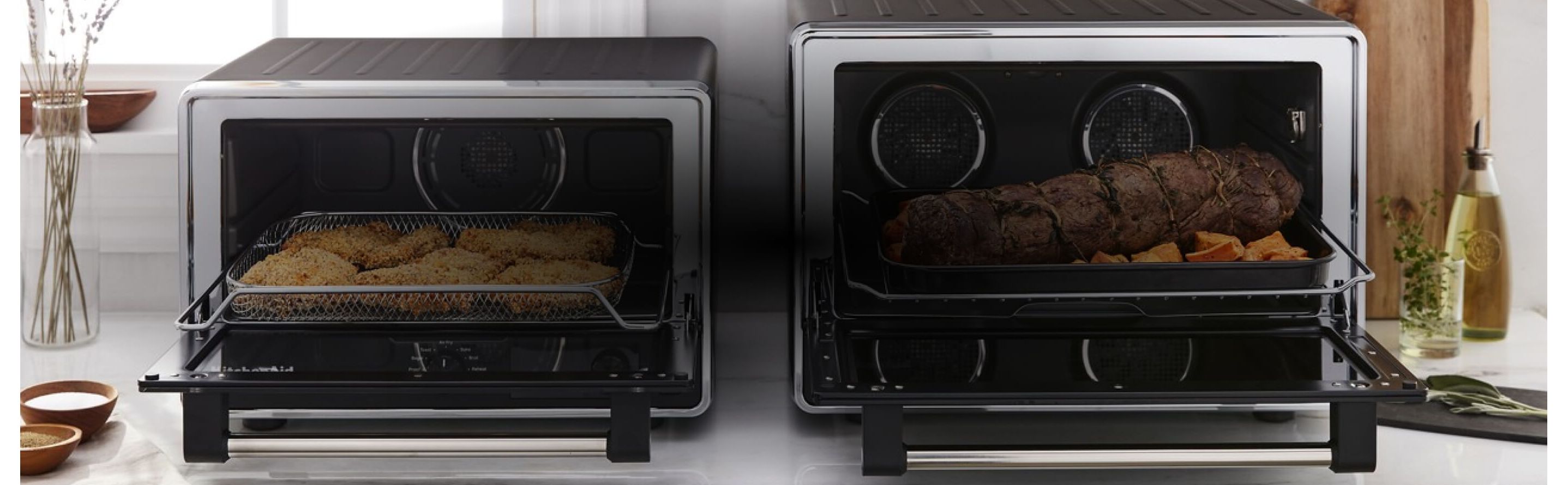 Two KitchenAid® Countertop Ovens resting on a kitchen counter.